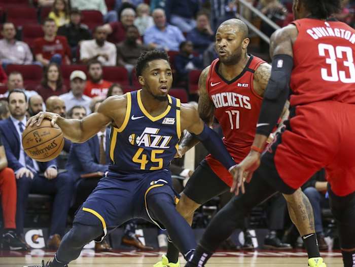 Donovan Mitchell (45) makes a move against PJ Tucker (17) and Robert Covington (33)